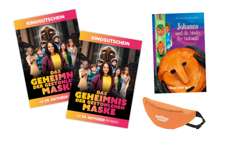 Eine Bauchtausche sowie das Buch-Cover und die Kino-Gutscheine zu "Das Geheimnis der gestohlenen Maske"